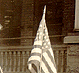 Thumbnail: Scanned photo of flag-decorated automobile (detail).