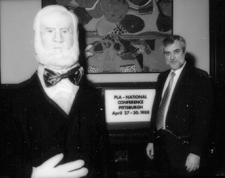 Photo of Bob Croneberger and larger than 
life-size image of Mr. Carnegie.