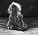 Thumbnail:_Photo_of_little_girl_on_bed_in_sunlight_and_shadow_(detail).