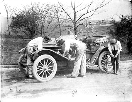 Photo_of_three_men_working_on_an_automobile_in_Schenley_Park.