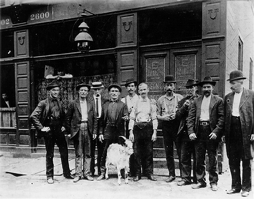 Photo_of_men_in_front_of_Sherrer's_Saloon_with_goat.