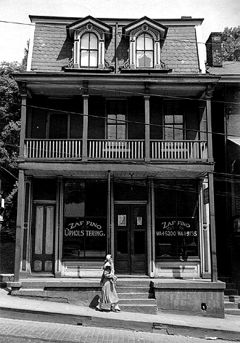 Photo_of_woman_walking_along_street.