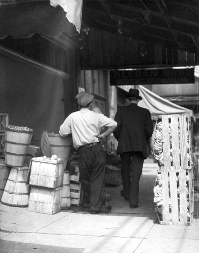 Photo_of_man_selling_produce_on_sidewalk.