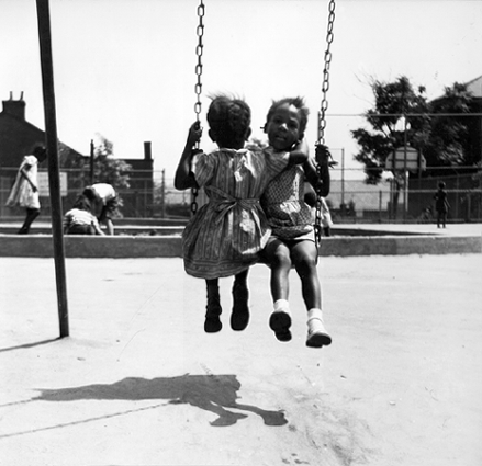 Photo_of_two_young_girls_on_swing.