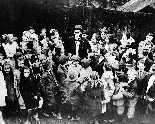 Photo of John Brashear surrounded by children.
